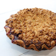 A 10" pie filled with strawberries and peaches and topped with struesel.